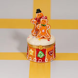 Gingerbread Couple Trinket Box shown from the front with two gingerbread figures on a round cookie-pattern base
