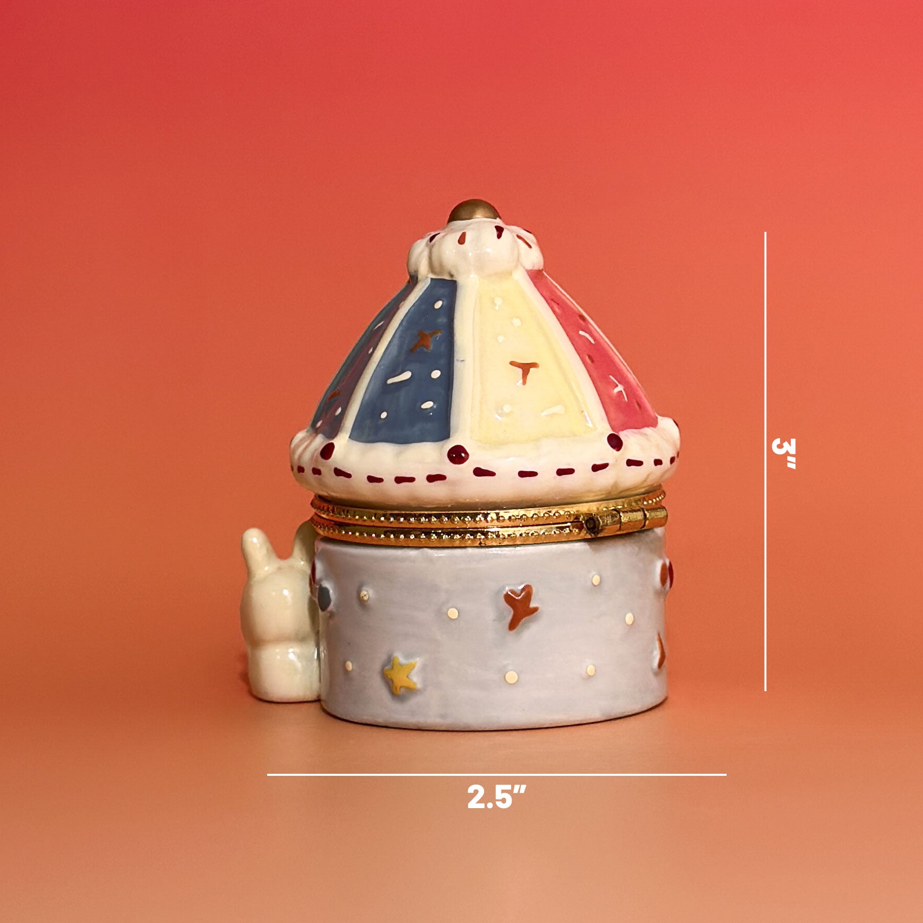 Hand-painted carousel bunny trinket box showing 2.5-inch width and 3-inch height on orange background.
