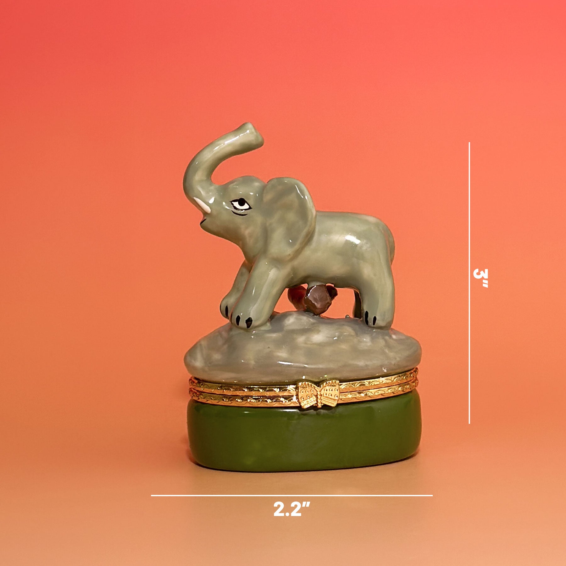 Elephant trinket box measurement photo showing 2.2-inch width and 3-inch height on warm orange gradient background.