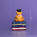 Back view of ceramic graduation bear trinket box on purple background with size markers — 3 inches tall, 2 inches wide