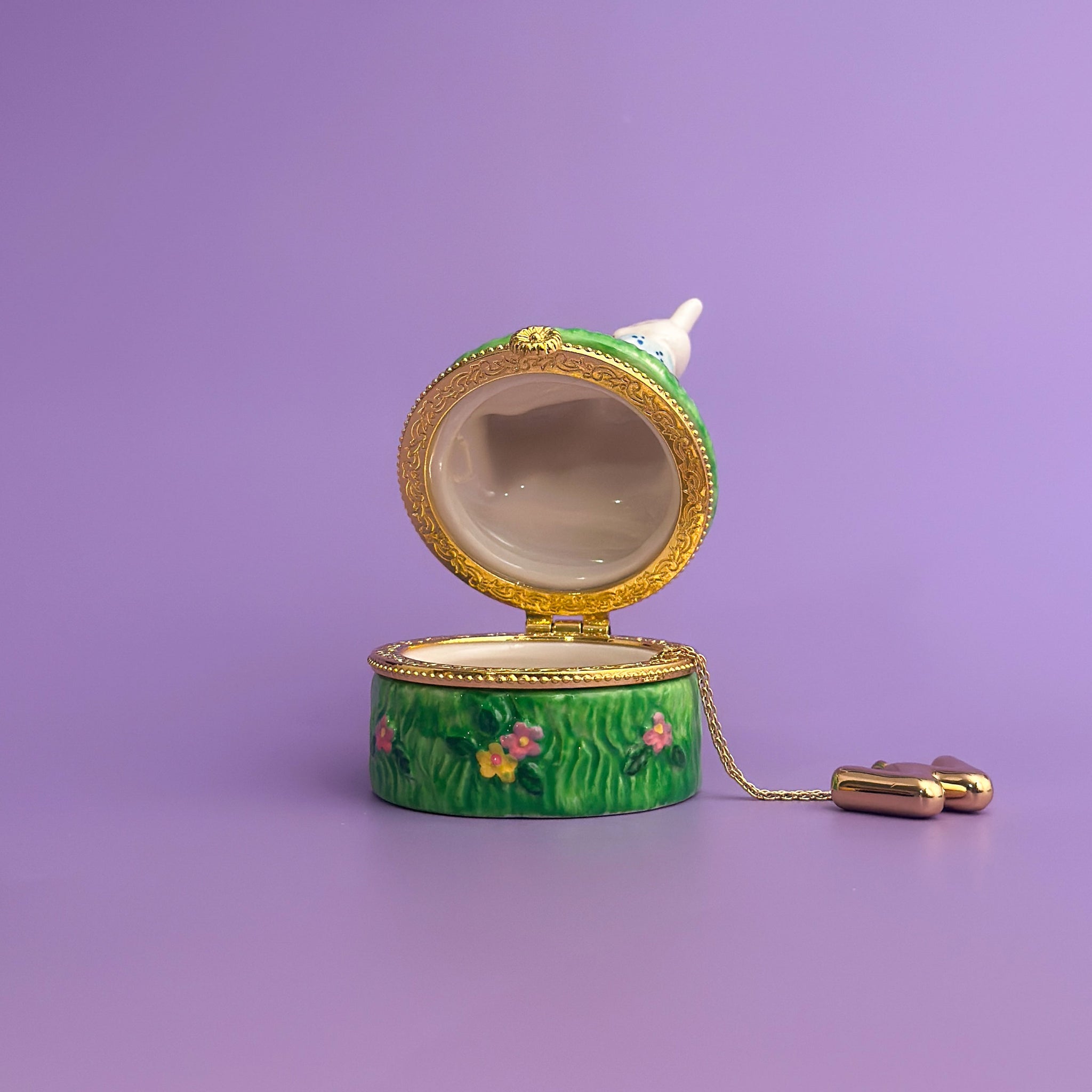 open ceramic bunny trinket box showing gold hinge and white interior