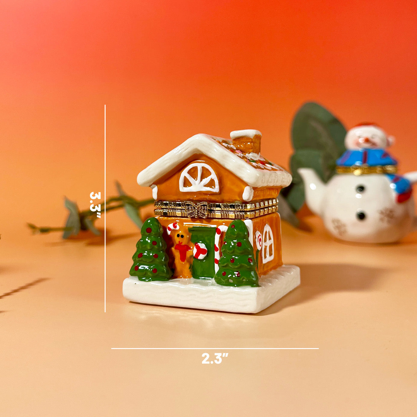 Hand-painted ceramic Gingerbread House Trinket Box with two trees in front, festive winter holiday design