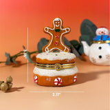 Hand-painted ceramic Gingerbread Man Trinket Box sitting on sugar frosting cake, festive winter decoration