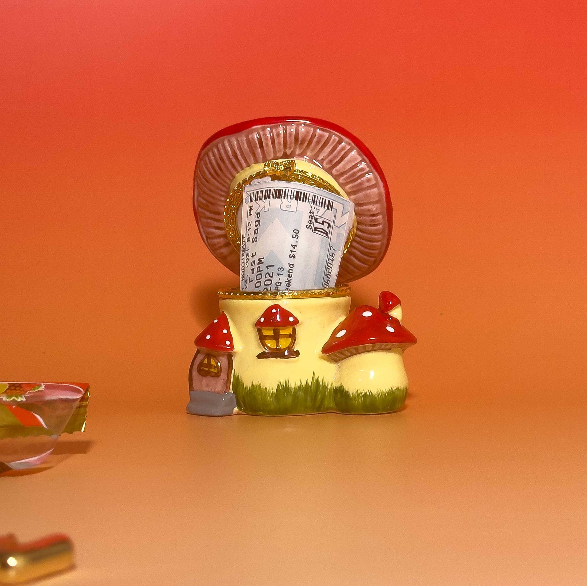 Mushroom Trinket Box with lid open, containing small notes inside, illustrating storage space